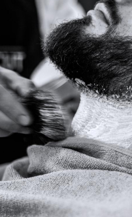 Barber shaving client with straight razor